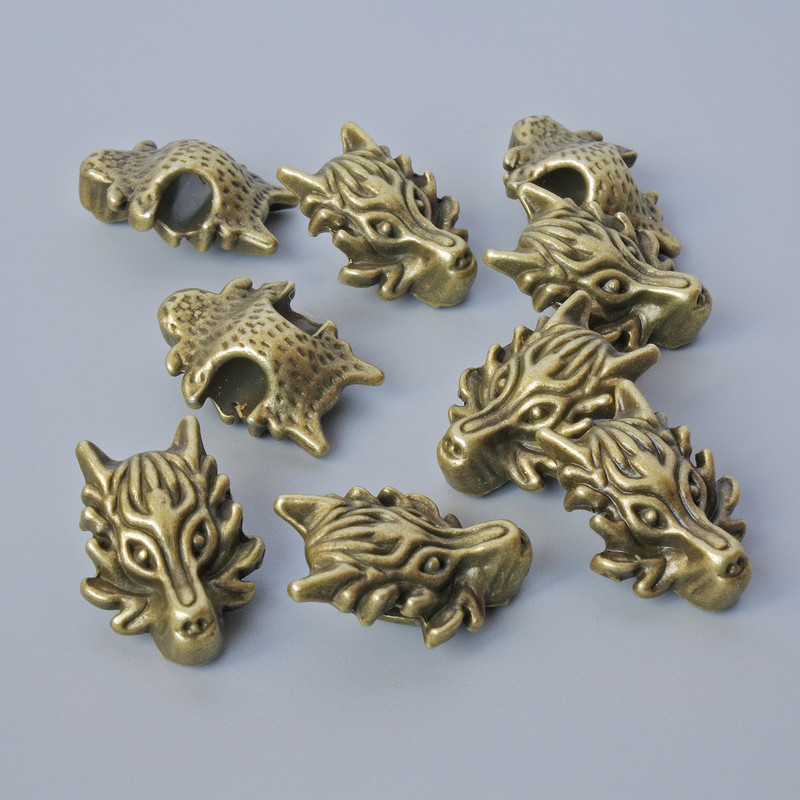 Finding Insert Bead "Dragon", diameter 18x13x8mm, hole diameter 3.7mm, pack 9pcs+/- bronze colour metal