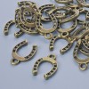 Findings pendant "Horseshoe", diameter 15x11mm, hole diameter 1.9mm, pack 24pcs+/- bronze colour metal