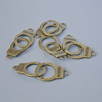 Findings Pendant "Handcuffs", diameter 23x14.5mm, hole diameter 2.4mm, length 40mm, pack of 5pcs +/- bronze metal colour