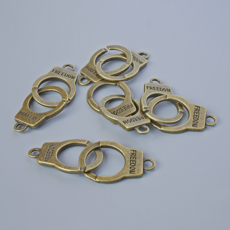 Findings Pendant "Handcuffs", diameter 23x14.5mm, hole diameter 2.4mm, length 40mm, pack of 5pcs +/- bronze metal colour