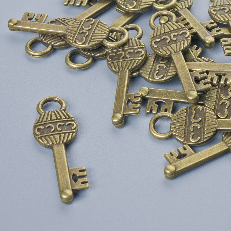 Finding Pendant "Key", 26x8mm, hole diameter 3.5mm, pack of 16pcs+/- bronze metal colour