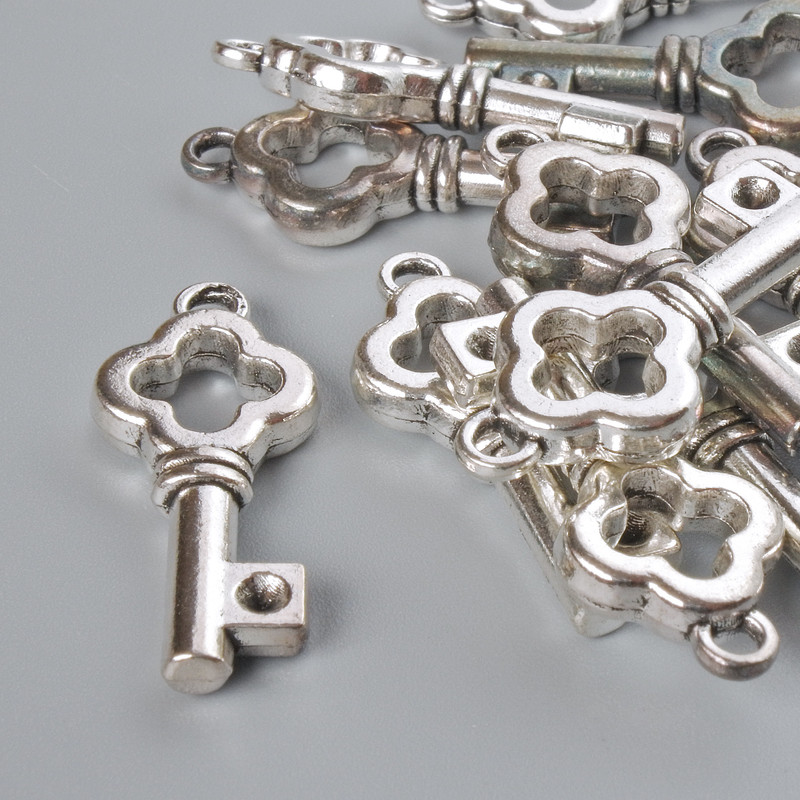 Finishing hardware Pendant Key 25x11mm polished, 12 pcs ± 20 g, silver-tone metal