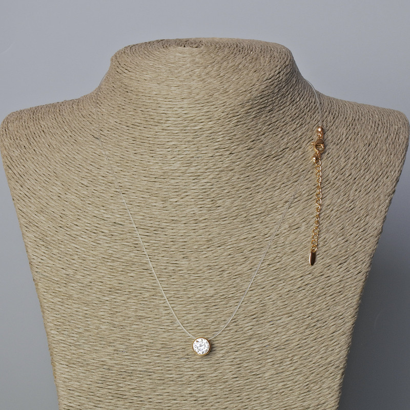 Pendant with White Crystal, 8.5mm diameter, 0.8mm thickness on nearly invisible thread with 18K gold plated clasp, length 45-50cm