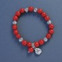 Coral (pressed) Bracelet, diameter 9mm+/-, length 18cm+/- stretch with Ladybird charm