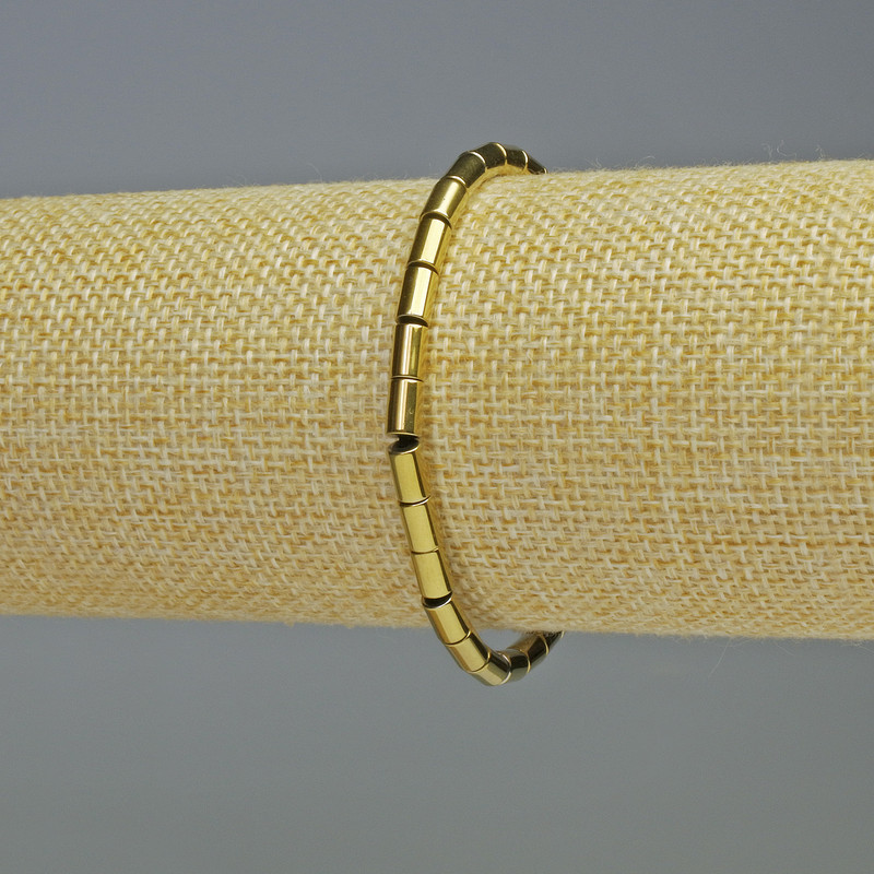 Hematite Cylinder Bracelet, gold colour, diameter 6x4mm ±, length 18cm ±, stretch