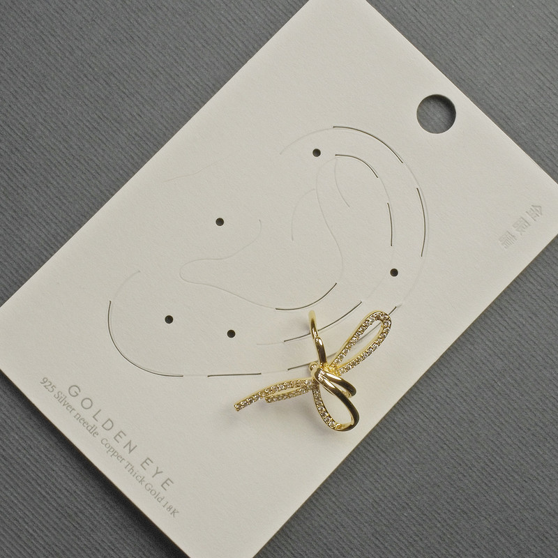 Earring Café 'Bow' on Ear with Golden Metal 17x30mm± White Crystals