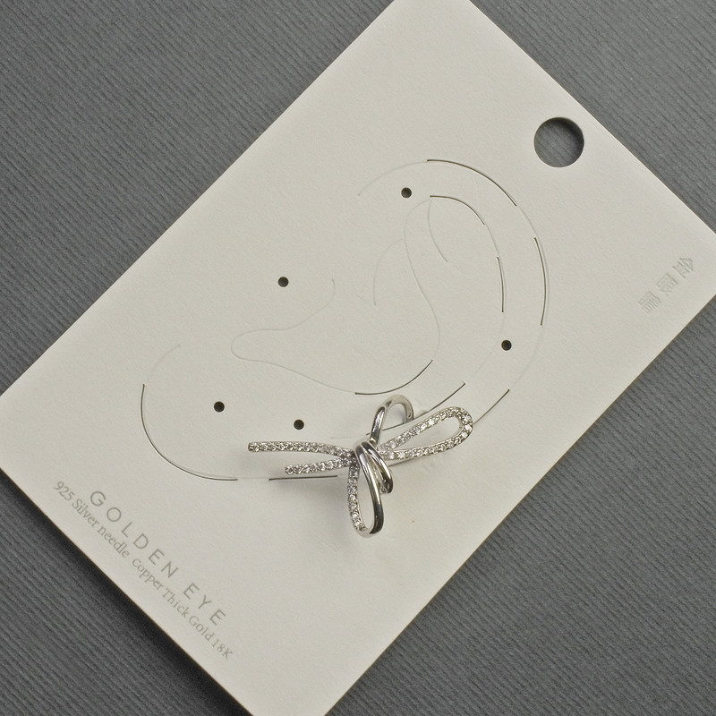 Earring café piercing 'Bow' in silver metal 17x30mm± white crystals