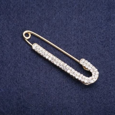 Brooch pin with white crystals 75x16mm+- golden metal