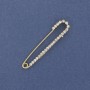 Brooch pin with white crystals 56×11mm± golden metal