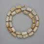 Fossilised coral cut beads 10-11×5-7mm+- beads 3mm+-, length 40cm+- on thread