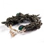 Bracelet with black faceted stones on a black sparkling strand on a macrame thread with a lobster clasp
