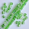 Crystal beads light green with purple sheen Swarovski-style, 2.5×4 mm on thread, 48 cm length