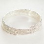 Spiral bracelet with four turns, white rhinestones, small beads, 18–22 cm circumference