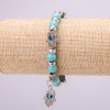 Turquoise charm bracelet (made with artificial turquoise) with blue "little eyes" on elastic, diameter 12 (±) mm, length 18 cm with inserts and a pendant