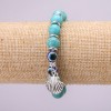 Turquoise talisman bracelet (single piece) with blue “evil eyes” on elastic, diameter 10 (+/-) mm, length 18 cm with inserts and a pendant