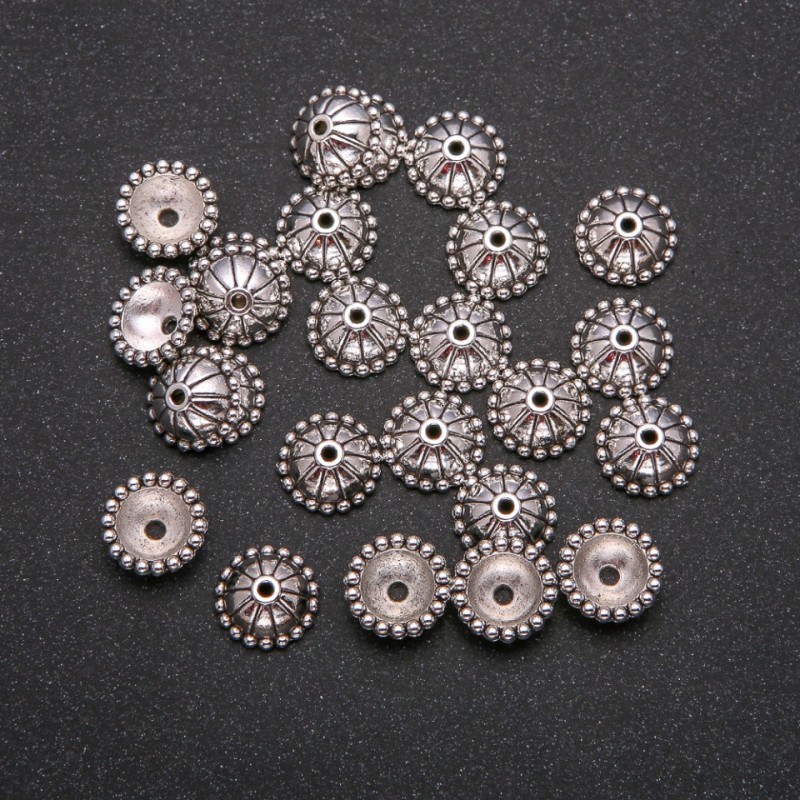 Findings end caps silver colour, diameter 11x4.5 (+/-) mm, packing -20 g. 28 (+/-) pcs
