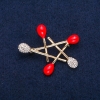 Star Brooch, Red Enamel and White Rhinestones, Gold-Tone Metal 36x44mm