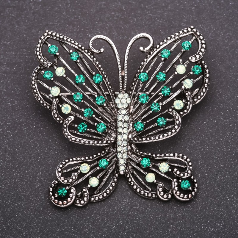 Brooch Butterfly with green rhinestones 52x56mm grey metal