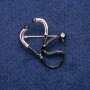 Brooch 'Stethoscope' with white crystal, black enamel, 33x29 mm, silver metal