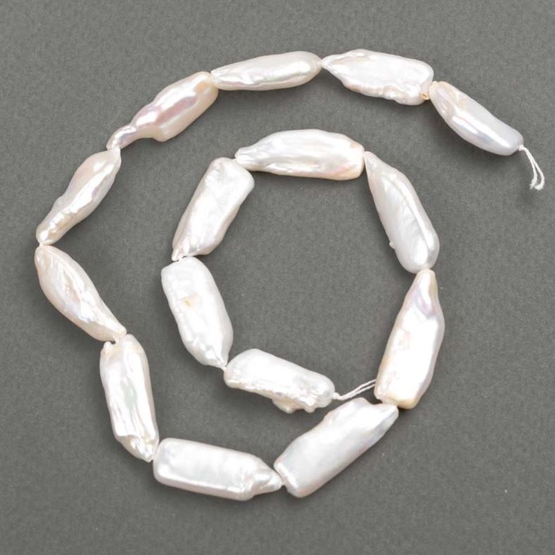 Baroque pearls with petrol tint on a thread d 26-32x10-11mm +-, thread length approximately 39 cm+