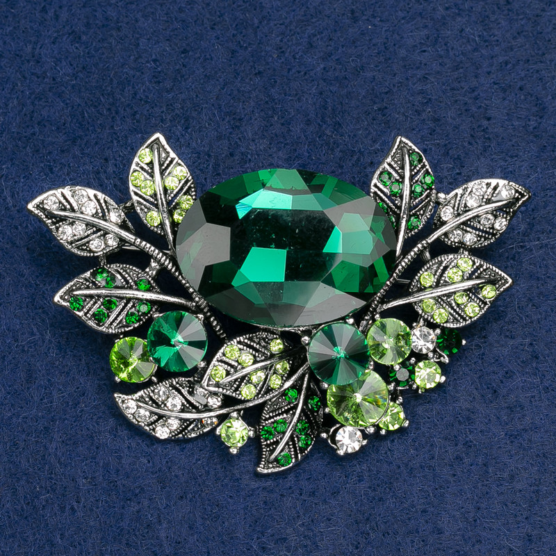 Brooch large Accent in a botanical design with rhinestones and green and white stone, silver-toned metal, 67x46mm