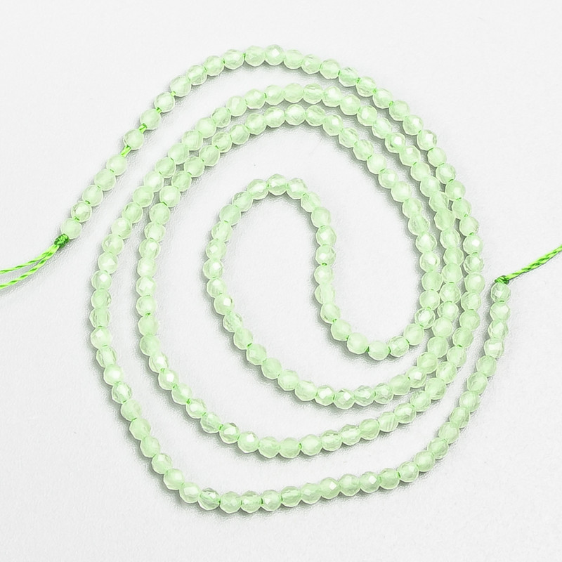 Small beads spinel (synth.) pale green faceted ball, diameter 2mm+/- on a thread, length 37cm