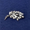 Twig Brooch with white cat's eye, white rhinestones, silver-tone metal, diameter 50x27mm+