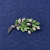 Twig Brooch with green cat's eye, white rhinestones, silver-tone metal, diameter 50x27mm+