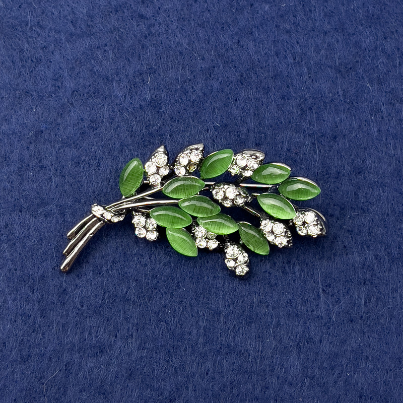 Twig Brooch with green cat's eye, white rhinestones, silver-tone metal, diameter 50x27mm+