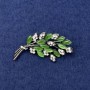 Twig Brooch with green cat's eye, white rhinestones, silver-tone metal, diameter 50x27mm+
