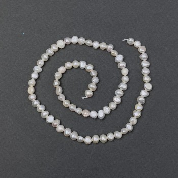 Freshwater pearls with petrol-blue tint on thread, diameter 5.5×4.5 mm, length 37 cm ±