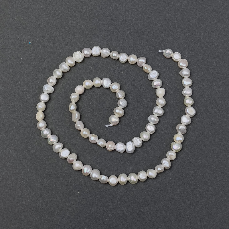 Freshwater pearls with petrol-blue tint on thread, diameter 5.5×4.5 mm, length 37 cm ±