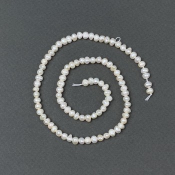 Freshwater pearls with petrol-toned hue on a thread, 5x4mm+-, length 35cm+-