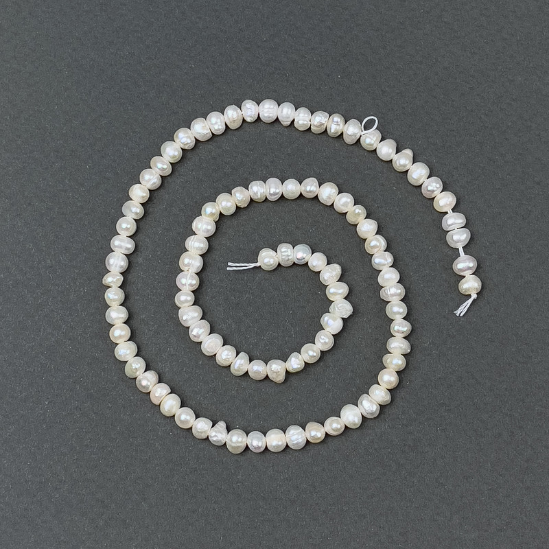 Freshwater pearls with petrol-toned hue on a thread, 5x4mm+-, length 35cm+-